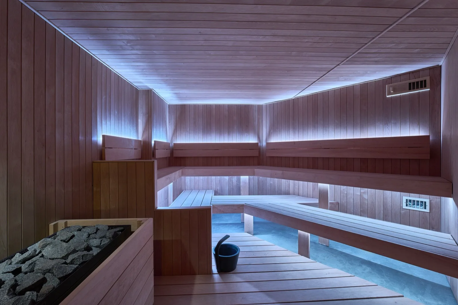 An empty dry-heat sauna in low warm light.